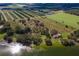 Aerial view of lakefront home and expansive farmland at 38230 Yale Cir, Leesburg, FL 34788