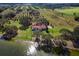 Aerial view of waterfront home and citrus grove at 38230 Yale Cir, Leesburg, FL 34788