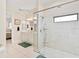 Bathroom with double vanity, large shower, and view of bedroom at 38230 Yale Cir, Leesburg, FL 34788