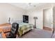 Bedroom with a double bed, ceiling fan, and an adjacent bathroom at 38230 Yale Cir, Leesburg, FL 34788