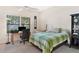 Bedroom with lake view, workspace, and ceiling fan at 38230 Yale Cir, Leesburg, FL 34788