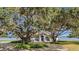 Home's exterior showcasing landscaping and large oak trees at 38230 Yale Cir, Leesburg, FL 34788