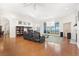 Spacious living room with hardwood floors, lake views, and comfortable seating at 38230 Yale Cir, Leesburg, FL 34788