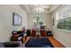 Bright home office features built-in shelving, hardwood floors, and a large window at 41 Camino Real Blvd # 41, Howey In The Hills, FL 34737