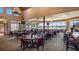 Elegant dining room with large windows and golf course views at 41 Camino Real Blvd # 41, Howey In The Hills, FL 34737