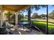 Screened porch with patio furniture and golf course view at 41 Camino Real Blvd # 41, Howey In The Hills, FL 34737