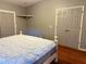 Bright bedroom with wood floors and double doors leading to the closet at 558 Saint Andrews Blvd, The Villages, FL 32159