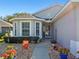 Front entrance with a stone walkway and landscaping at 5608 Squires Dr, Leesburg, FL 34748