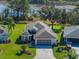 Single-Gathering home with two-car garage and landscaped yard, offering lake views at 5620 Squires Dr, Leesburg, FL 34748