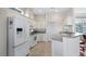 White kitchen with stainless steel appliances and an island at 5715 Blue Savannah Dr, Leesburg, FL 34748