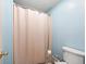 Clean bathroom with shower/tub combo and beige shower curtain at 712 Tarrson Blvd, The Villages, FL 32159