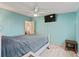 Bedroom with light blue walls and a double bed, offering a view of the kitchen at 712 Tarrson Blvd, The Villages, FL 32159