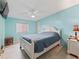 Bedroom with light blue walls, ceiling fan, and a comfortable bed at 712 Tarrson Blvd, The Villages, FL 32159