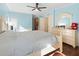 Main bedroom with light blue walls, a large bed, and ample dresser space at 712 Tarrson Blvd, The Villages, FL 32159