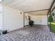 Covered patio area with brick pavers and a grill at 712 Tarrson Blvd, The Villages, FL 32159