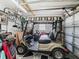 Garage with golf cart, bicycle, and storage space at 712 Tarrson Blvd, The Villages, FL 32159