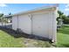 White garage with single door and paved pathway at 712 Tarrson Blvd, The Villages, FL 32159