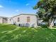 Exterior view of single-story house with green lawn at 712 Tarrson Blvd, The Villages, FL 32159