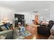 Living area with hardwood floors, sectional sofa, and a view of the kitchen at 712 Tarrson Blvd, The Villages, FL 32159