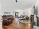 Spacious living room with wood floors, a large TV, and comfortable seating at 712 Tarrson Blvd, The Villages, FL 32159