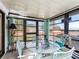 Relaxing sunroom with glass windows and a small table and chairs at 712 Tarrson Blvd, The Villages, FL 32159