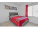 Guest bedroom with red bedding and large window at 7715 Indian Ridge N Trl, Kissimmee, FL 34747