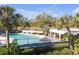 Community pool with lounge chairs and picnic tables at 7715 Indian Ridge N Trl, Kissimmee, FL 34747