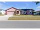 Brick and shingle ranch home with a two-car garage and landscaped yard at 7715 Indian Ridge N Trl, Kissimmee, FL 34747