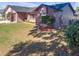 Side view of a ranch home showcasing landscaping at 7715 Indian Ridge N Trl, Kissimmee, FL 34747
