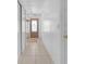 Hallway with tiled floors and access to the front door and other rooms at 7715 Indian Ridge N Trl, Kissimmee, FL 34747