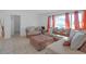 Spacious living room featuring a sectional sofa and large windows at 7715 Indian Ridge N Trl, Kissimmee, FL 34747