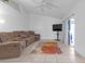 Spacious living room with sectional sofa and large TV at 7715 Indian Ridge N Trl, Kissimmee, FL 34747