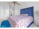 Main bedroom with large blue velvet headboard and red bedding at 7715 Indian Ridge N Trl, Kissimmee, FL 34747