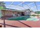 Screened pool area with patio and lounge chairs at 7715 Indian Ridge N Trl, Kissimmee, FL 34747