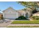 One-story home with a two-car garage and landscaped lawn at 9651 Old Marsh Ct, Orlando, FL 32832