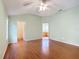 Main bedroom with vaulted ceiling, wood floors, and ensuite bathroom at 108 Costa Mesa Dr, Lady Lake, FL 32159