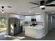 Modern kitchen featuring white cabinets, stainless steel appliances, and an island at 11 The Crescent, Minneola, FL 34715