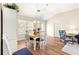 Bright dining room with wood table and chairs, hardwood floors, and access to living areas at 1103 Salido Ave, The Villages, FL 32159