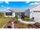 Landscaped front yard with walkway leading to house entry at 1103 Salido Ave, The Villages, FL 32159