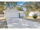 House exterior showcasing a two-car garage and well-maintained lawn at 12151 Woodglen Cir, Clermont, FL 34711