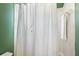 Bathroom with a white shower curtain and white tiled walls at 14701 Timucua Pl, Clermont, FL 34711