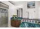 Bathroom with a green vanity, soaking tub, and shower at 14701 Timucua Pl, Clermont, FL 34711