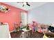 Playful bedroom with a coral wall and a wooden play kitchen at 14701 Timucua Pl, Clermont, FL 34711