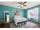 Bedroom with teal walls, ceiling fan, and access to a private patio at 14701 Timucua Pl, Clermont, FL 34711