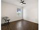 Spacious bedroom with dark wood floors and a ceiling fan at 14701 Timucua Pl, Clermont, FL 34711