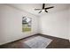 Well-lit bedroom with wood floors and a large window at 14701 Timucua Pl, Clermont, FL 34711