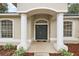 Elegant entryway with double doors and columns at 14701 Timucua Pl, Clermont, FL 34711