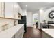 Modern kitchen features white and gray cabinets, quartz countertops, and stainless steel appliances at 14701 Timucua Pl, Clermont, FL 34711