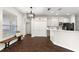 Bright kitchen features a breakfast bar, dark wood floors, and white cabinets at 14701 Timucua Pl, Clermont, FL 34711
