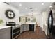 Modern kitchen with stainless steel appliances and gray cabinets at 14701 Timucua Pl, Clermont, FL 34711